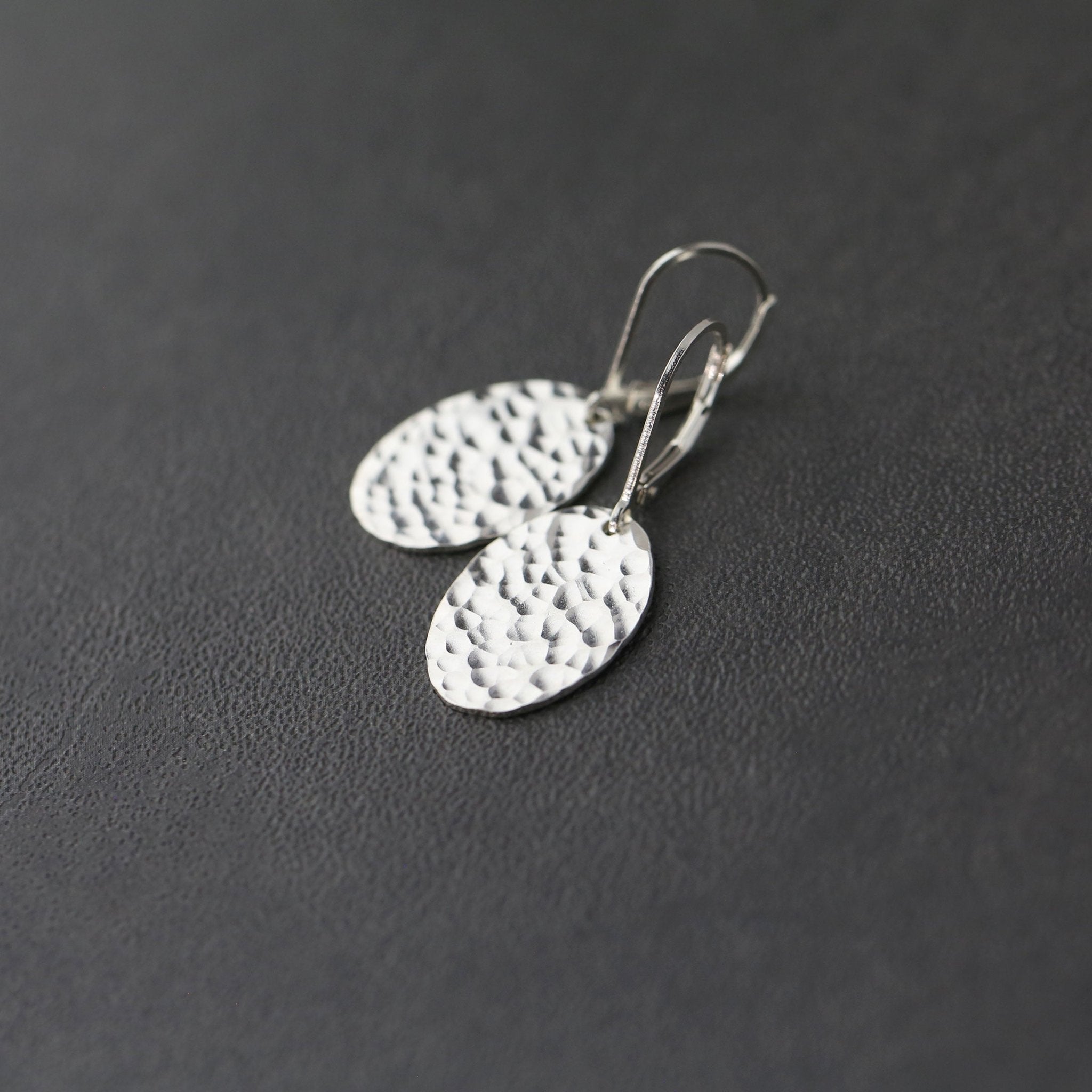 Oval Hammered Silver Lever-back Earrings handmade by Burnish