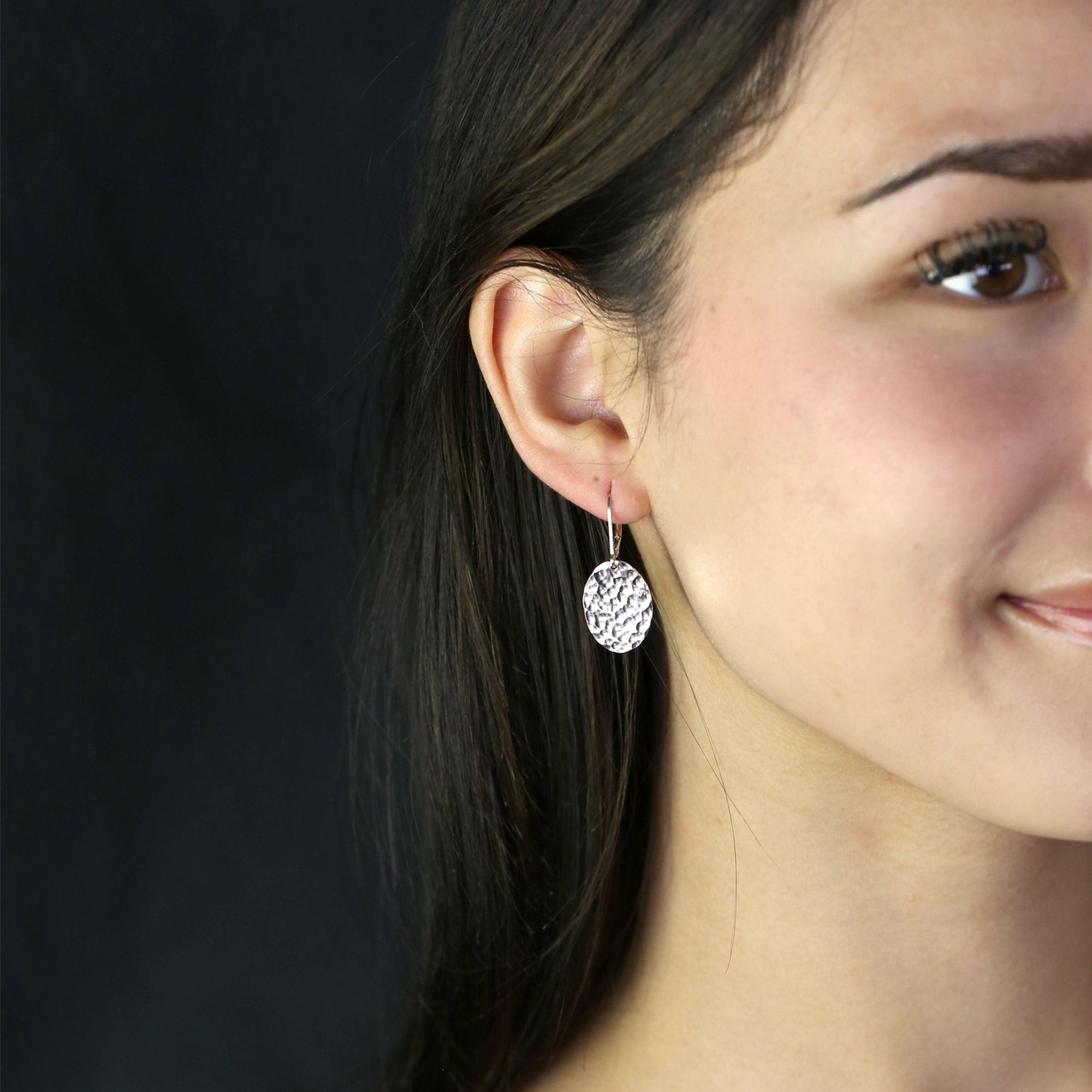 Oval Hammered Silver Lever-back Earrings handmade by Burnish