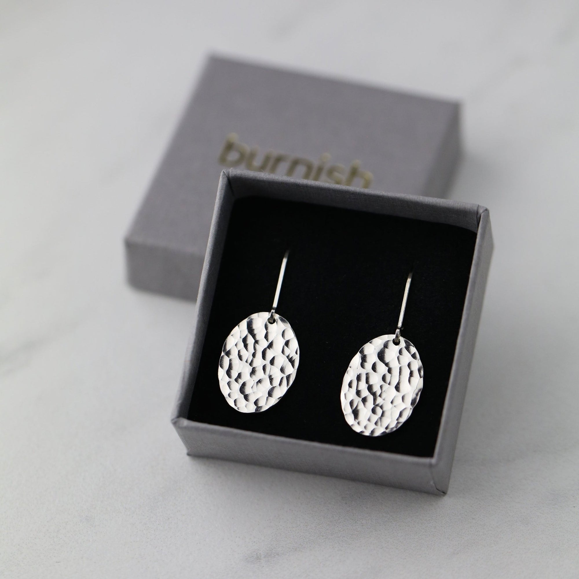 Oval Hammered Silver Lever-back Earrings handmade by Burnish